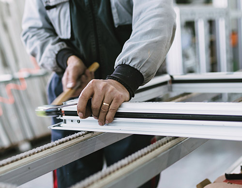 man preparing windows at warehouse