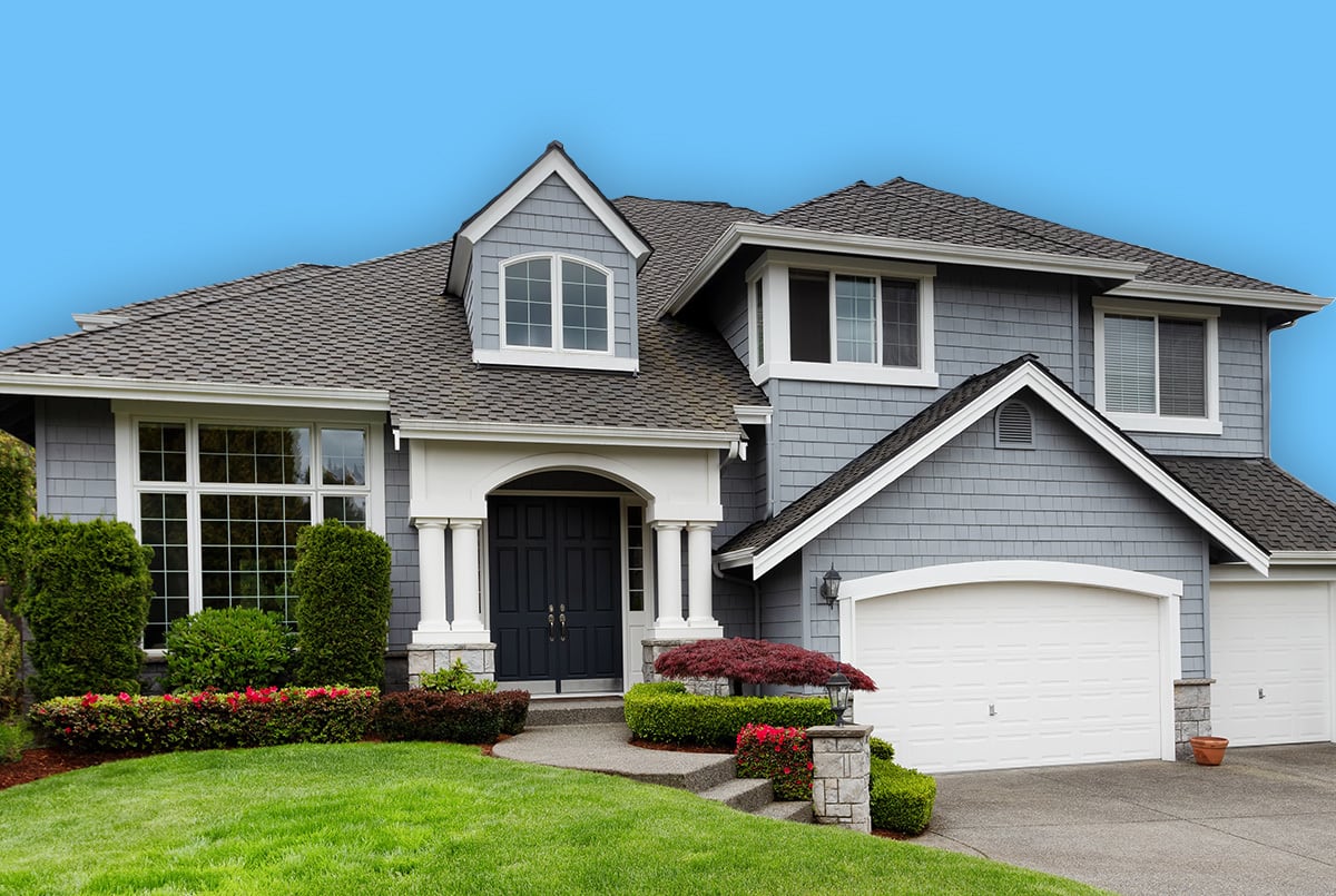 Wide shot of blue home with green lawn