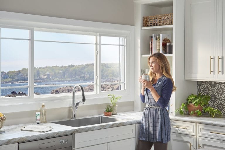 woman standing in kitchen with sliding windows