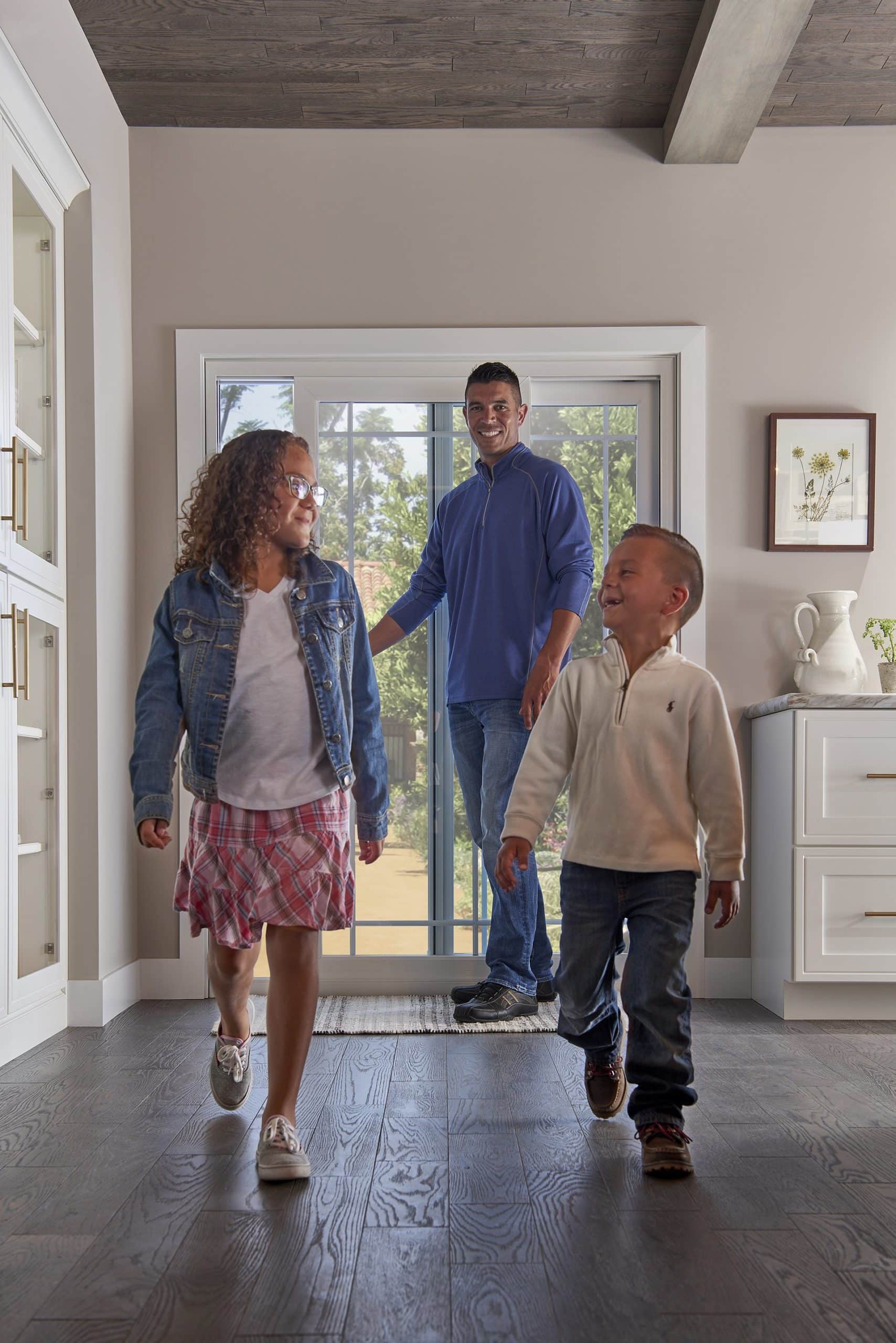 family walking into home