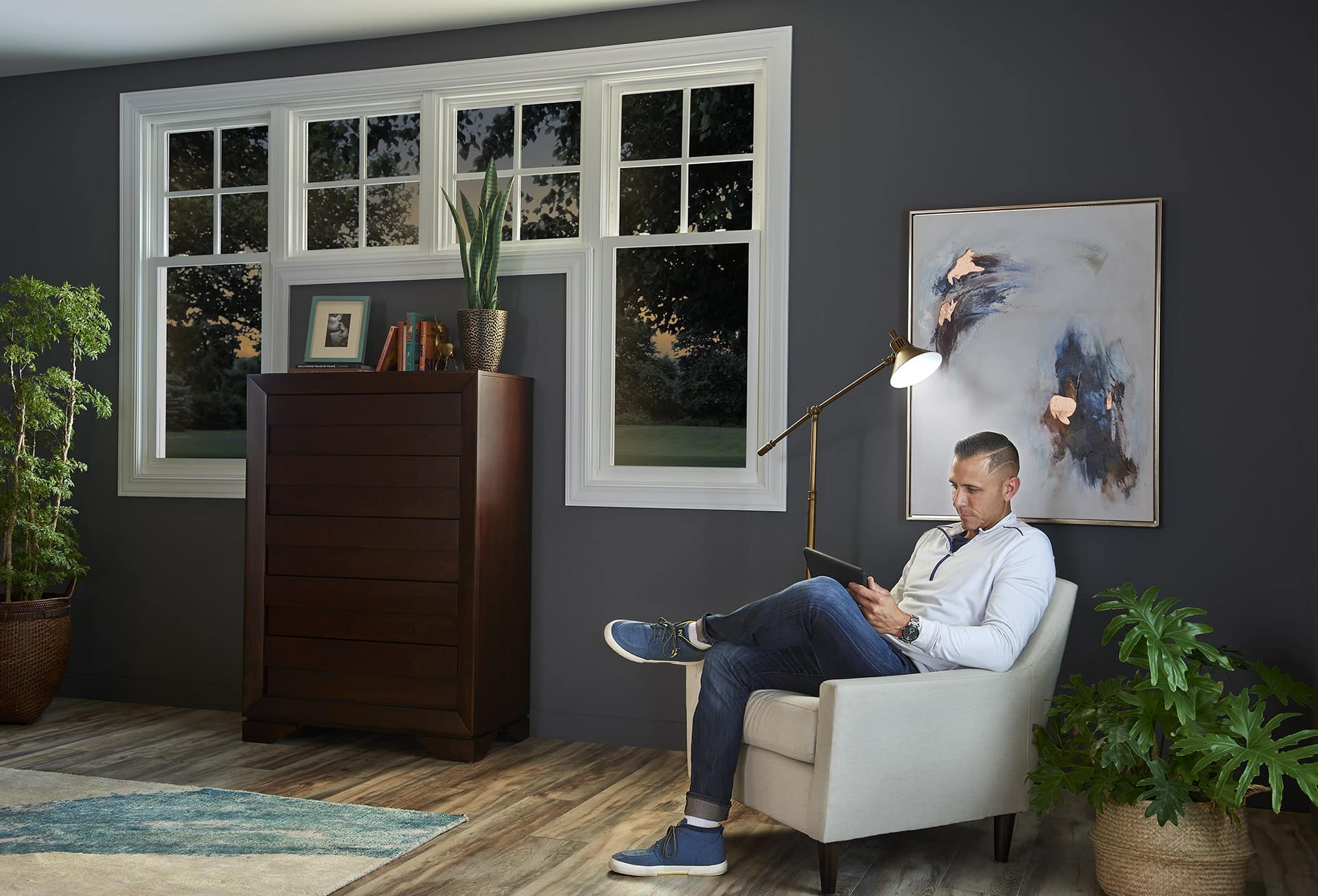 Man sitting and reading by lamp